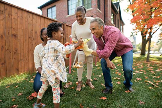 Active grandparents playing outdoors with grandchildren